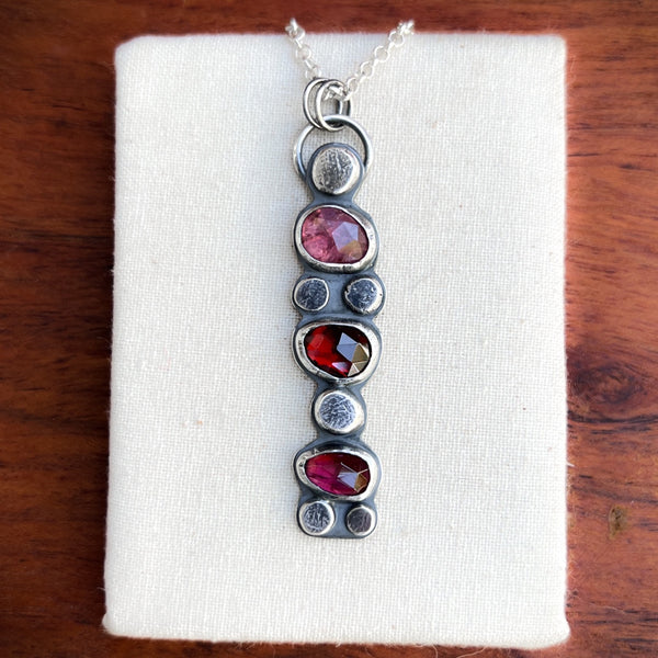 Cairn pendant: Winza sapphire, red garnet, rhodolite garnet